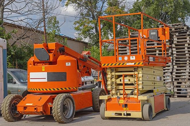 forklift carrying pallets in warehouse in New Boston